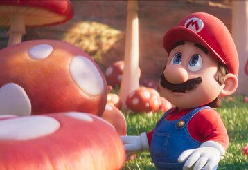 Animationsfigur Super-Mario zwischen Fliegenpilzen